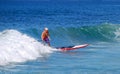 Paddle boarder surfing at St. Anns Beach in Laguna Beach, California.