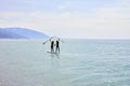 Paddle boarders. young man and woman on stand up paddleboard at sea, rear view Royalty Free Stock Photo