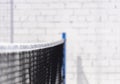 Paddle tennis and tennis net on blue court. Tennis competion concept. Horizontal sport poster, greeting cards, headers, website