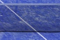 Paddle tennis net and blue court field background. Close up Royalty Free Stock Photo