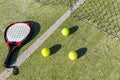 Paddle tennis racket, balls and net on court Royalty Free Stock Photo