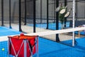 Paddle tennis rackets, balls and basket in court still life