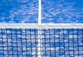 Paddle tennis and tennis net on blue court. Tennis competion concept. Horizontal sport poster, greeting cards, headers, website