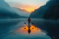 Paddleboarder on a calm lake at dawn Royalty Free Stock Photo
