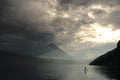Paddleboarder on a mountian lake after storm Royalty Free Stock Photo