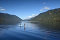 Paddleboarding couple on Lake Crescent in Olympic National Park, Washington.