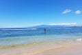 Paddleboarding along Maui shoreline.