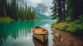 A paddleboat resting on the shore of a calm lake surrounded by pine Royalty Free Stock Photo