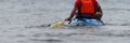 A paddler races his ocean kayak