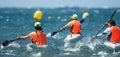 Paddlers race their ocean kayak