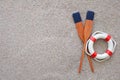 Paddles and life buoy lying on a sand Royalty Free Stock Photo