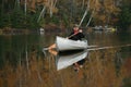 Paddling a Canoe on an Autumn Lake Royalty Free Stock Photo