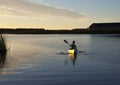 Paddling canoe at sunset Royalty Free Stock Photo