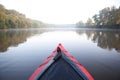 Paddling kayak on foggy river