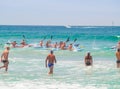 Paddling out through waves out in surf club competition Royalty Free Stock Photo