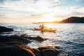 Paddling yellow sea kayak at sunset sea Royalty Free Stock Photo