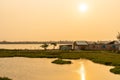 Paddy field in sunset time. Asian countryside landscape. Rural village scenery