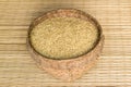 Paddy rice in bamboo basket on mat weave background Royalty Free Stock Photo