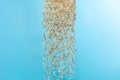 Paddy white Rice grain fly in mid air. Yellow Golden Paddy Rice falling scatter, explosion float in shape form line group. Blue