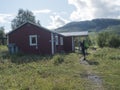 Padjelanta, Norrbotten, Sweden, Agust 14, 2021: Man hiker backapacker in front of STF Sammarlappa Mountain cabin at