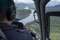 Close up of a Helicopter Pilot in Cockpit flying aircraft over Rivers