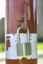 A padlock attached to a red-white pole