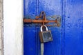 Padlock and bolt on blue door Royalty Free Stock Photo