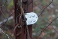 Padlock on an brown iron gate with a metal mesh Royalty Free Stock Photo