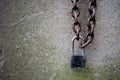 Padlock and chain against stone wall Royalty Free Stock Photo