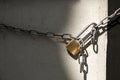 Padlock and chain isolated on wall background Royalty Free Stock Photo