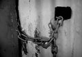 Padlock and chain on a rustic corrugated iron wall - black and white Royalty Free Stock Photo