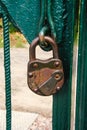 Locked old, antique padlock on the green gate. Royalty Free Stock Photo