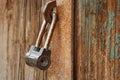 Padlock on gates. A rusty lock hangs on the shed door Royalty Free Stock Photo