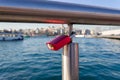 Padlock hanged on bridge iron railing