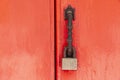 Padlock hangs on the red wooden door Royalty Free Stock Photo