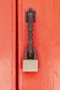 padlock hangs on the red wooden door Royalty Free Stock Photo