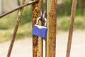 A padlock hangs on a rusty gate. Security concept, data protection, password and account hacking. Pick up the keys for the lock. Royalty Free Stock Photo