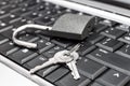 Padlock with keys on the laptop keyboard. Close up Royalty Free Stock Photo