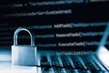 Padlock on laptop with a programming language. Internet data privacy information security concept. Antivirus and malware defense