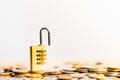 Padlock lying on coins stack.