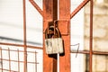 A padlock of the old style on the gate.