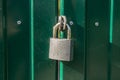 A padlock of the old style on the gate.