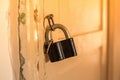 Padlock on an old wooden door close up