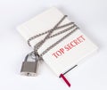 A padlock protects the book in a concept on protect the top secret information Royalty Free Stock Photo