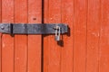 Padlock on the red wooden door Royalty Free Stock Photo