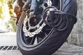 Padlock security lock blocking the motorcycle wheel on street, anti-theft system Royalty Free Stock Photo