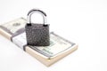 Padlock and US dollar banknotes bundle