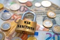 Padlock with `war sanctions` text next to money. Economic sanctions.