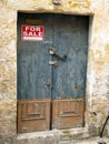 Padlocked Blue and Tan Door to a House for Sale