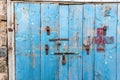 Padlocks on a weathered blus door